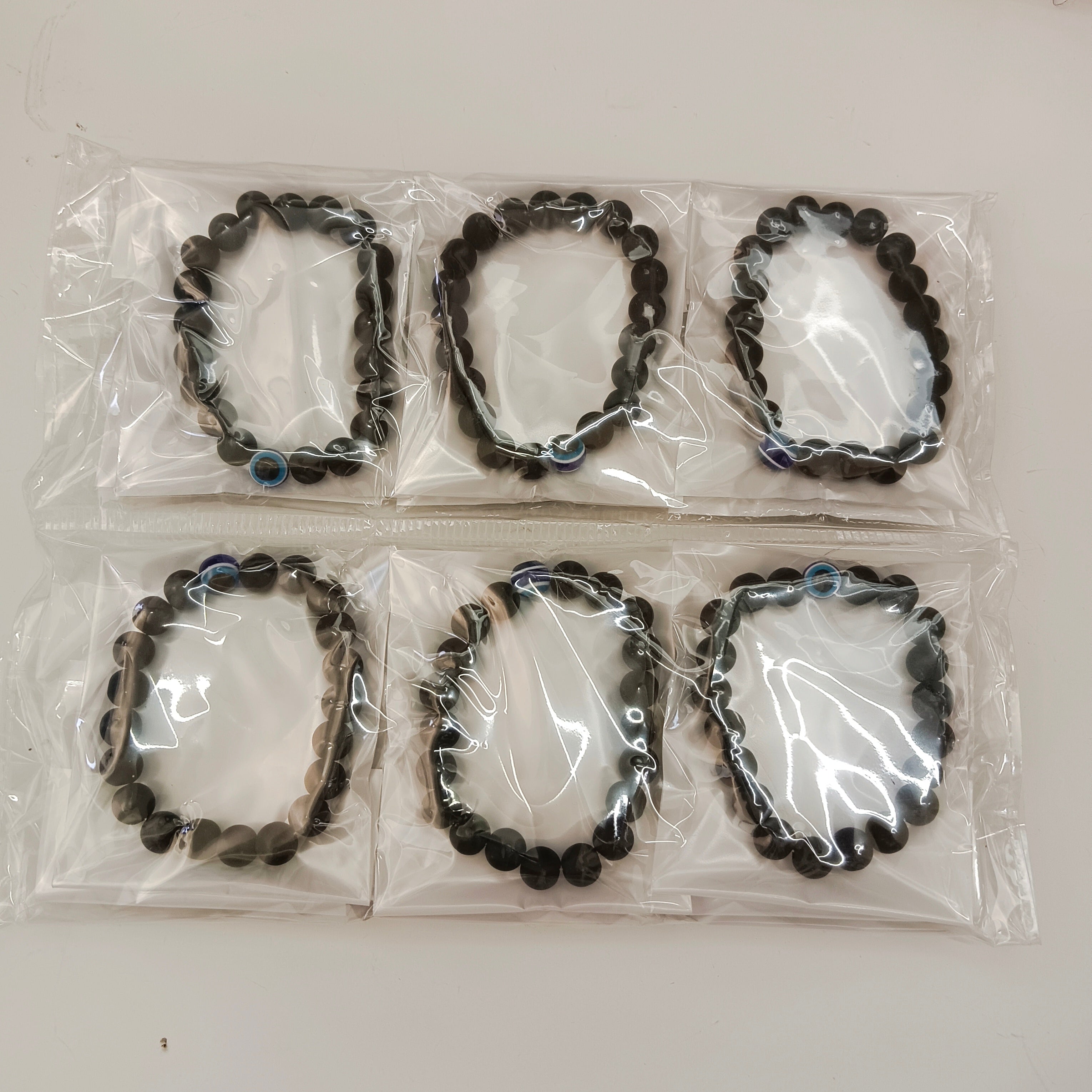 Urthn Evil Eye Black Beads Bracelet (Set Of 12)