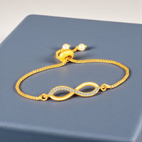 Mahi Infinity Adjustable Bolo Bracelet with Gold Plating for Women & Girls | Crystal-Studded Charm (BR1101091GWhi)