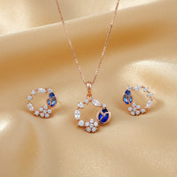 Etnico Latest Stylish Rose Gold Plated CZ American Diamond Pendant Brass Necklace Set with Earrings for Women