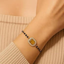 Etnico Gold Plated Traditional Adjustable Black Beads Mangalsutra Bracelet with White Pendant for Women (MB013Y)